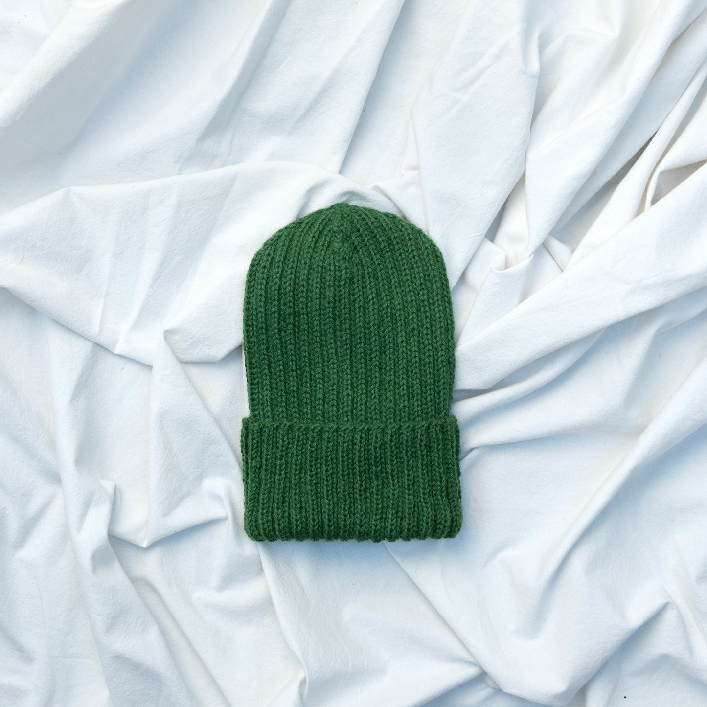Green coloured soft beanie with rib detail hand knitted with alpaca wool