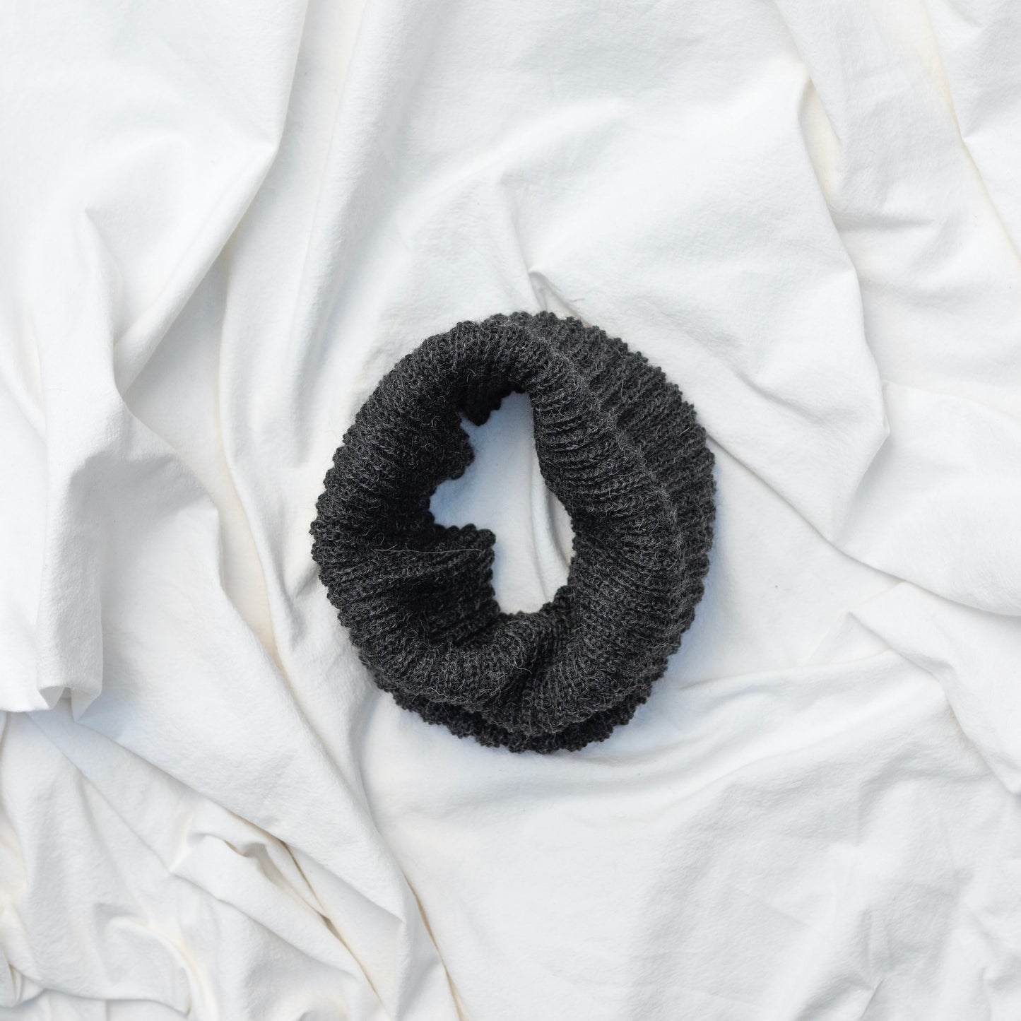 Dark grey coloured neck warmer made from the softest baby alpaca wool