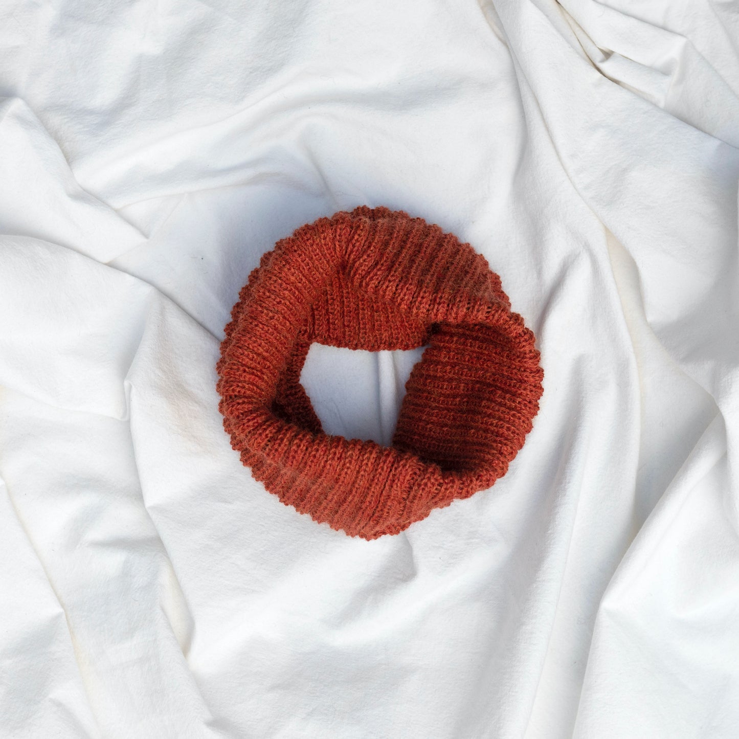 Orange coloured neck warmer made from the softest baby alpaca wool