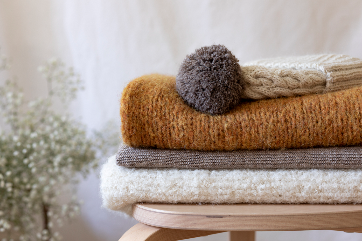 Premium hand-knitted scarf and hat on stool 