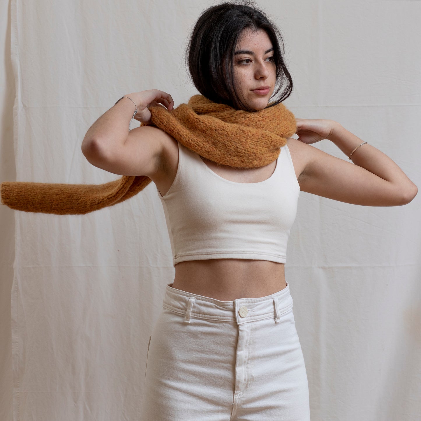 Woman wearing chunky super-soft knitted scarf in colour yellow.