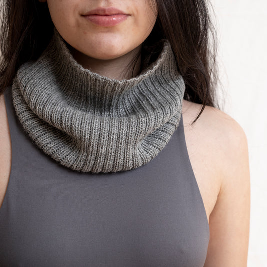 Woman wearing stone coloured neck warmer made from the softest baby alpaca wool.