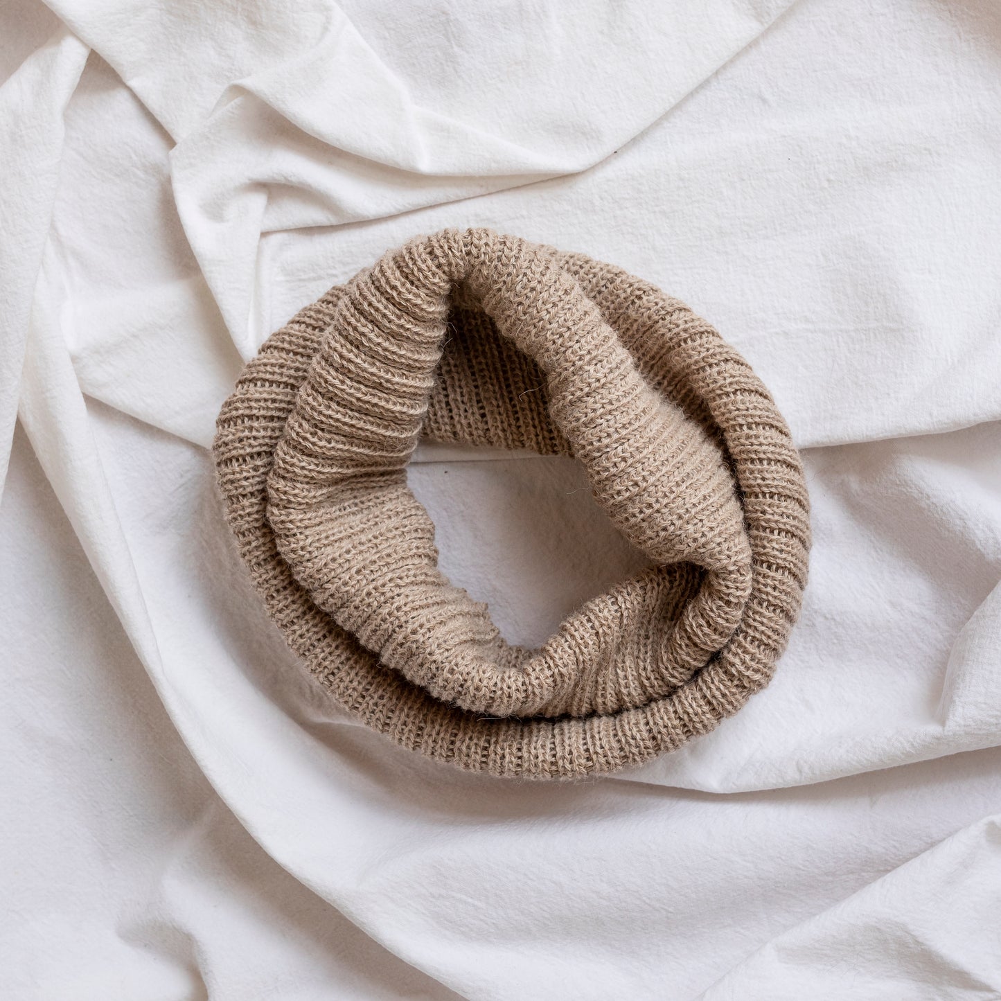 Oatmeal coloured neck warmer made from the softest baby alpaca wool.