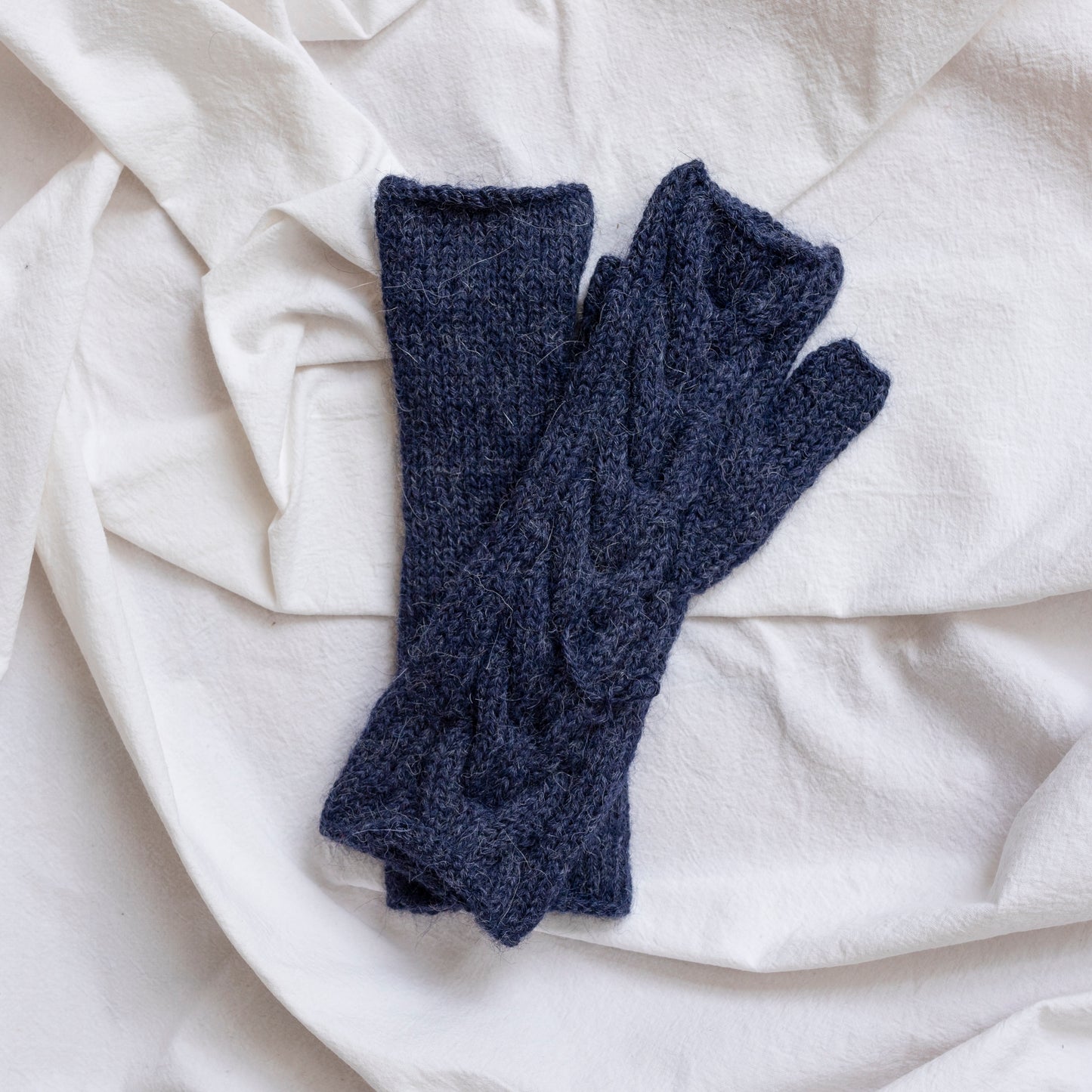 Dark blue coloured, super-soft and silky hand-knitted alpaca wool mittens.