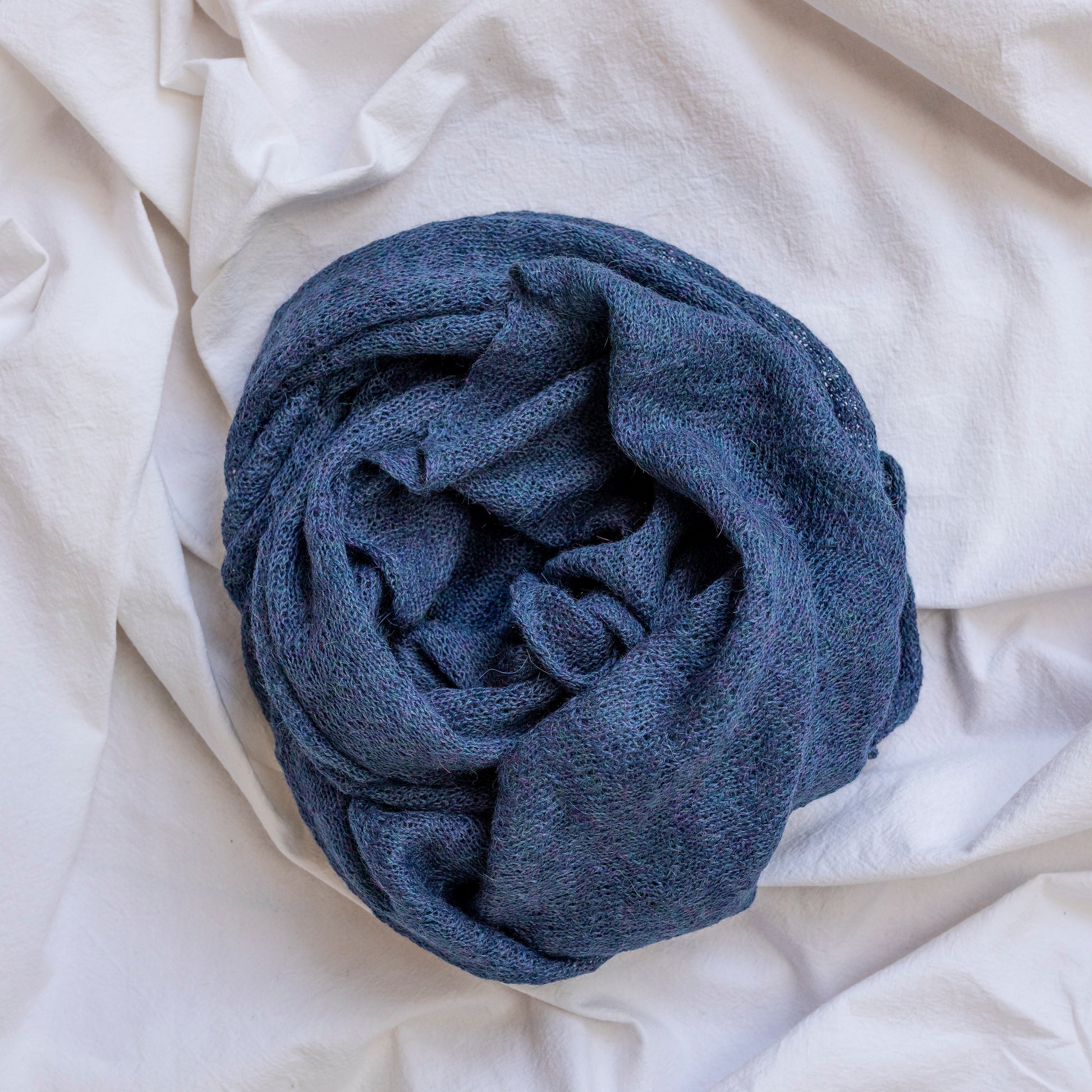Light blue coloured lightweight and delicately woven scarf. Hand-made by artisans.