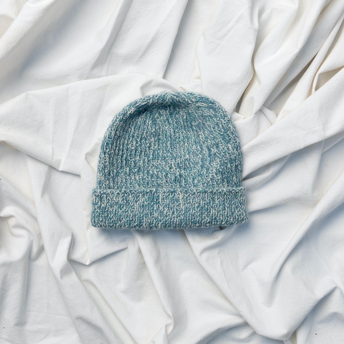Soft and luxurious alpaca knit Fishermans beanie in light blue and cream colour 