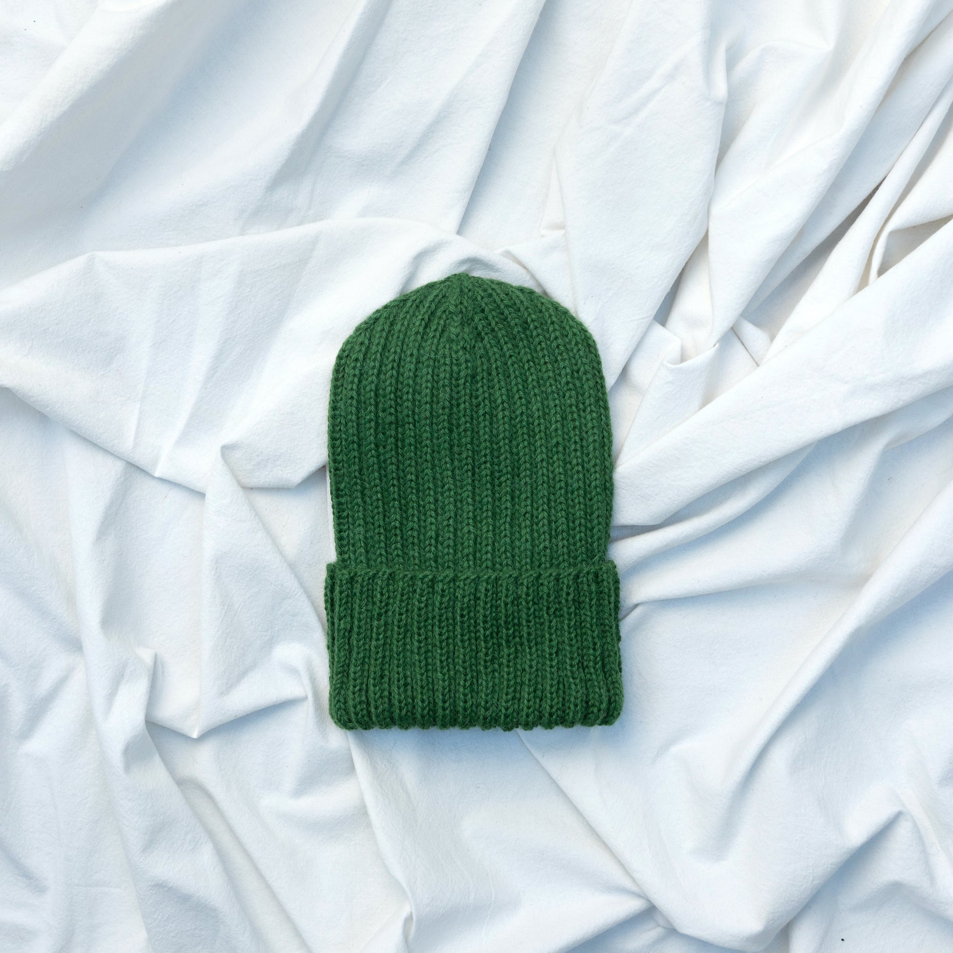 Green coloured soft beanie with rib detail hand knitted with alpaca wool 