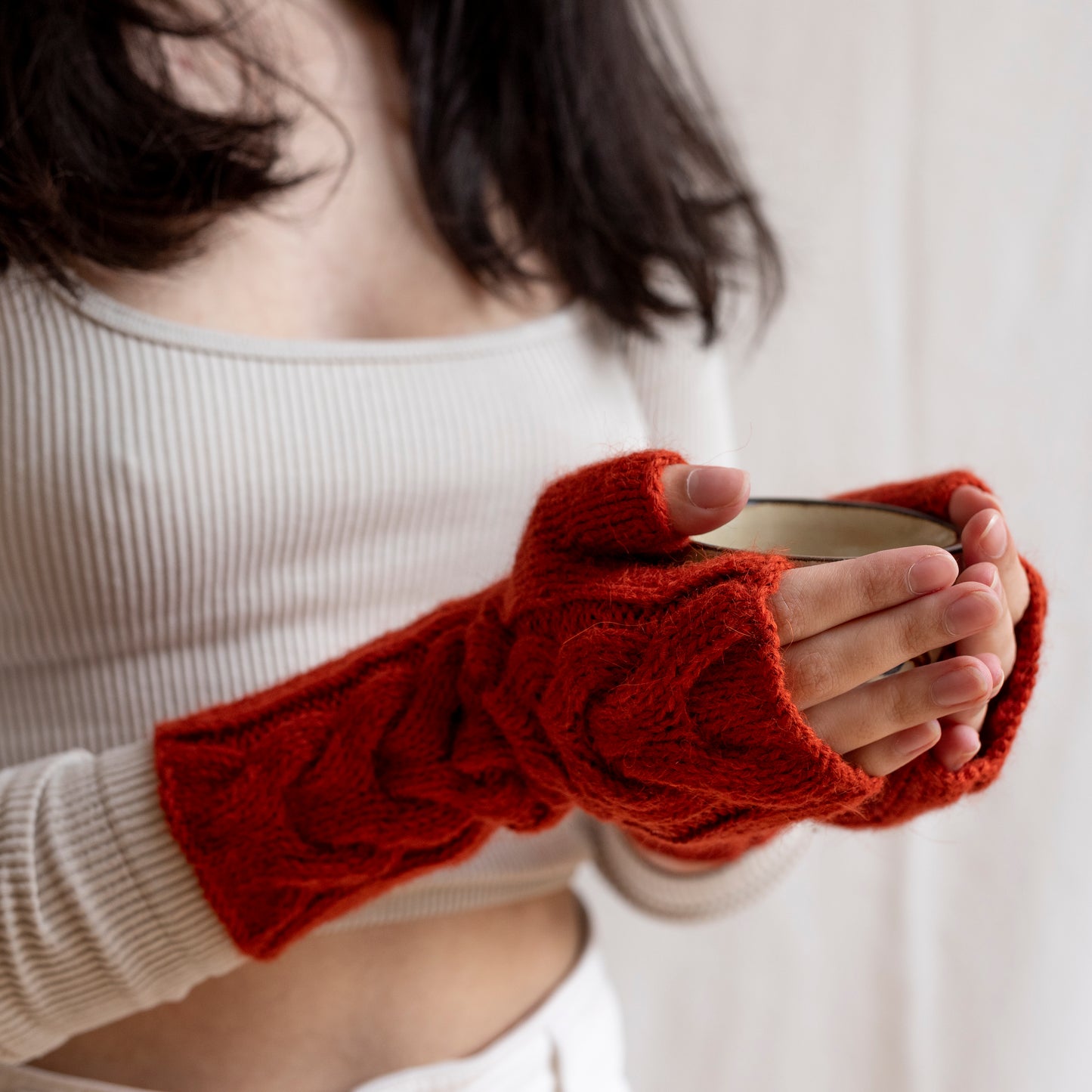 Burgundy coloured, super-soft and silky hand-knitted alpaca wool mittens.