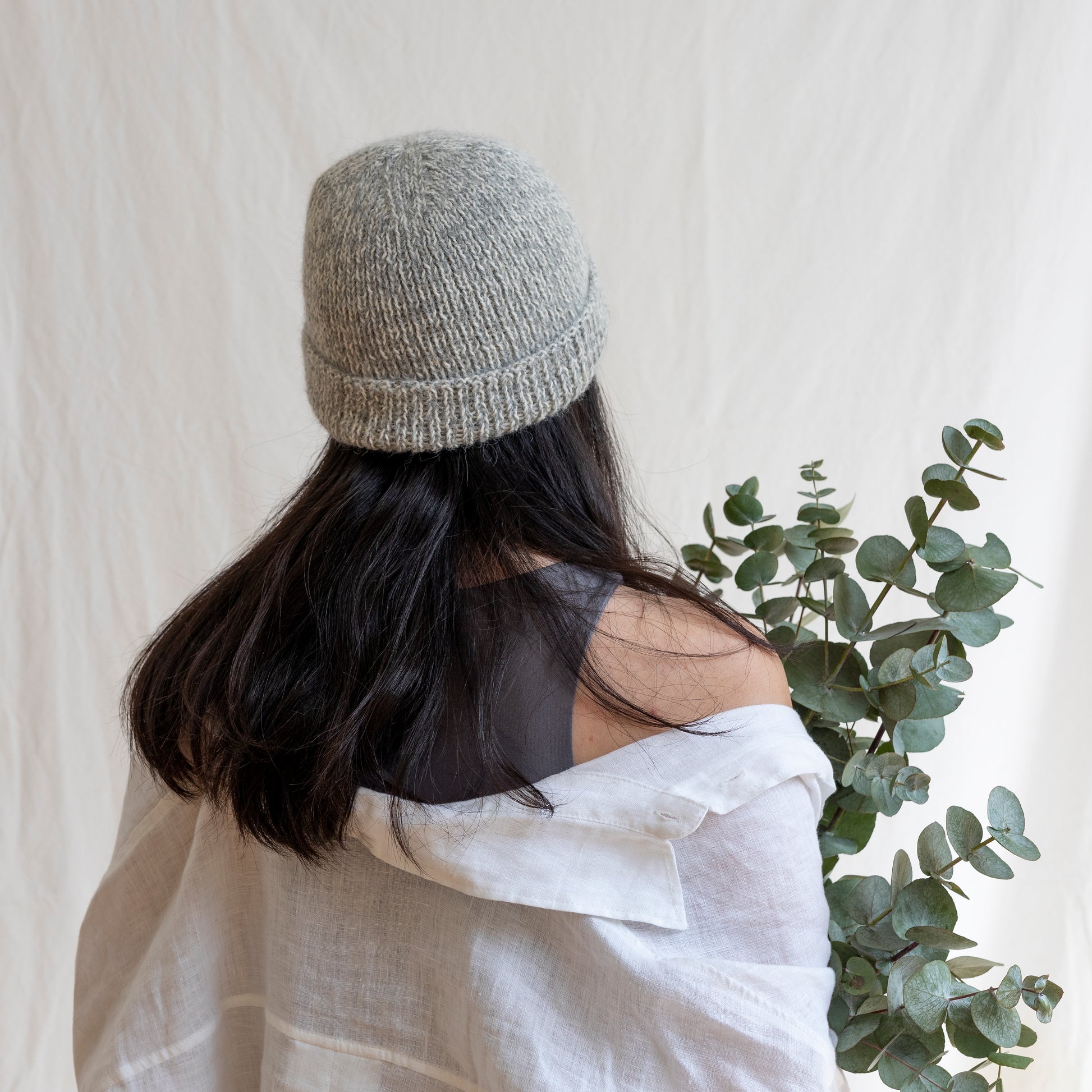 Woman wearing soft and luxurious alpaca knit fisherman's beanie in color stone. 