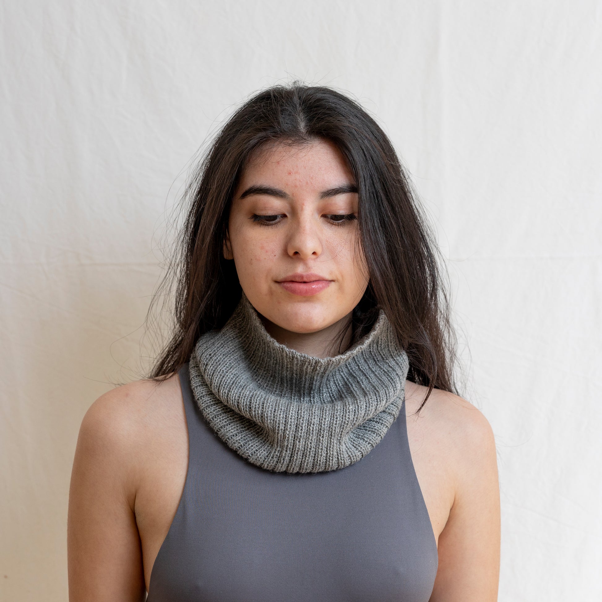 Woman wearing stone coloured neck warmer made from the softest baby alpaca wool. 