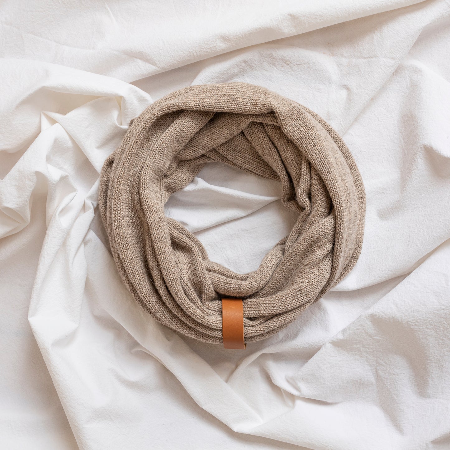 Oatmeal coloured luxury infinity scarf with leather strap detail.