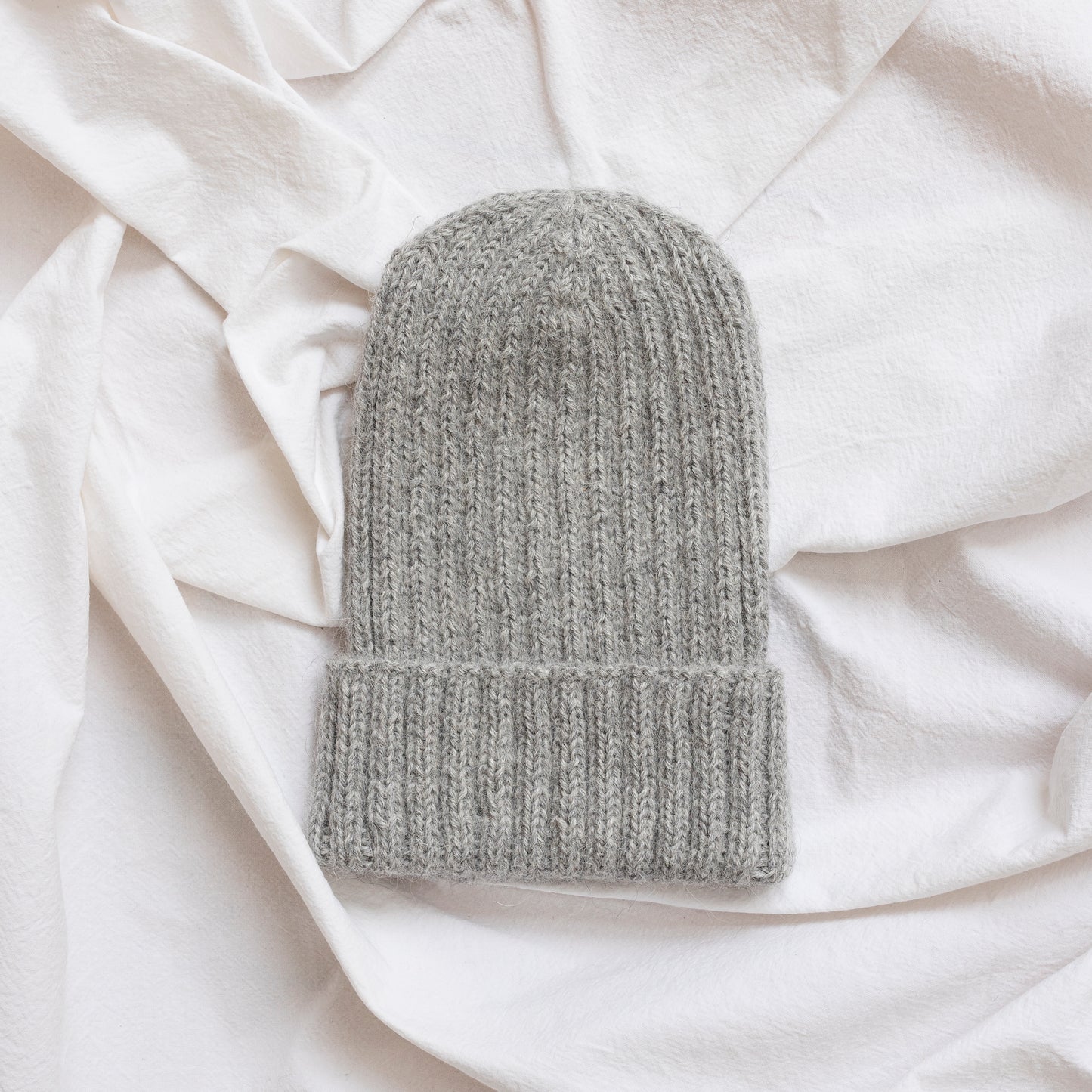 Soft grey coloured soft beanie with rib detail made from alpaca wool.