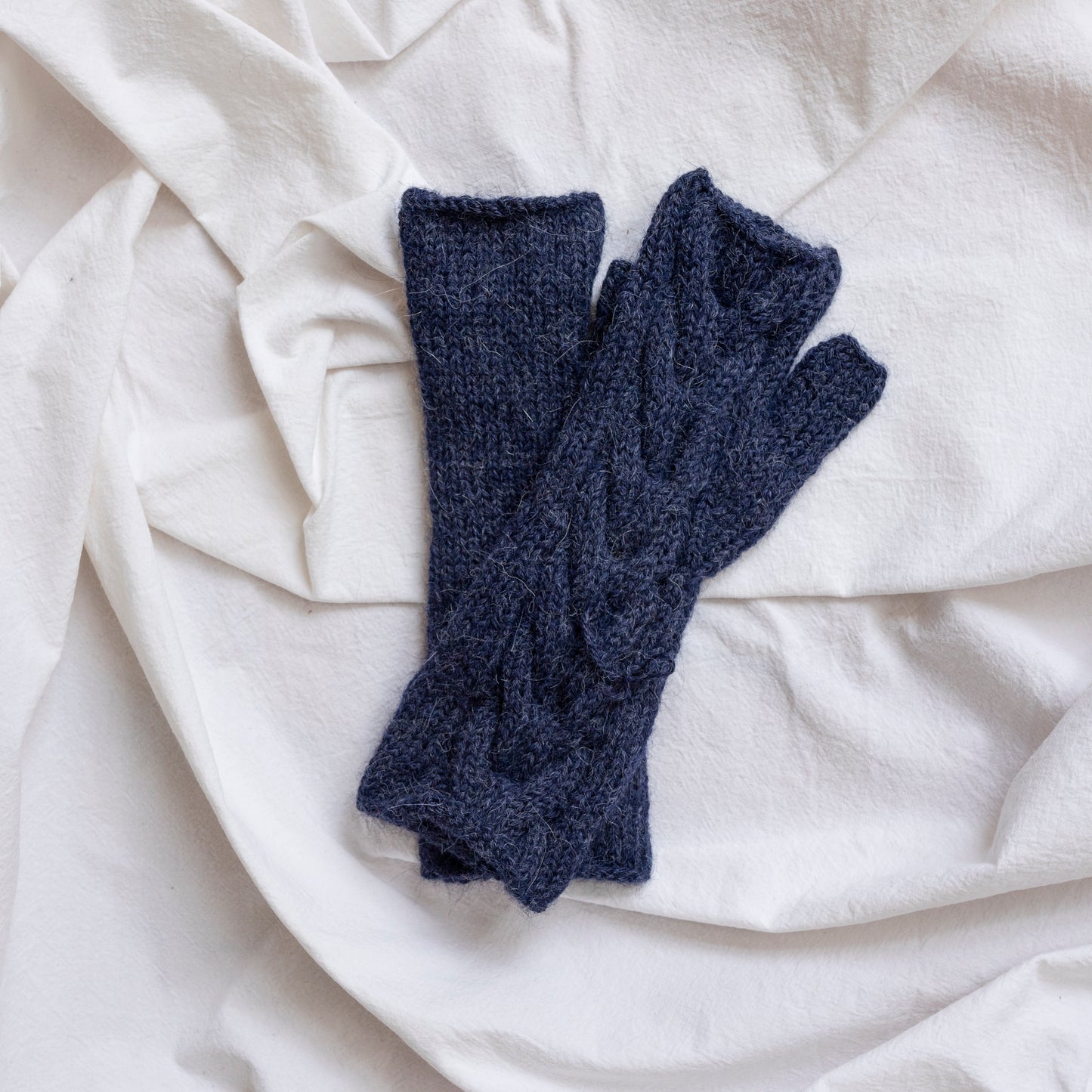 Dark blue coloured, super-soft and silky hand-knitted alpaca wool mittens.
