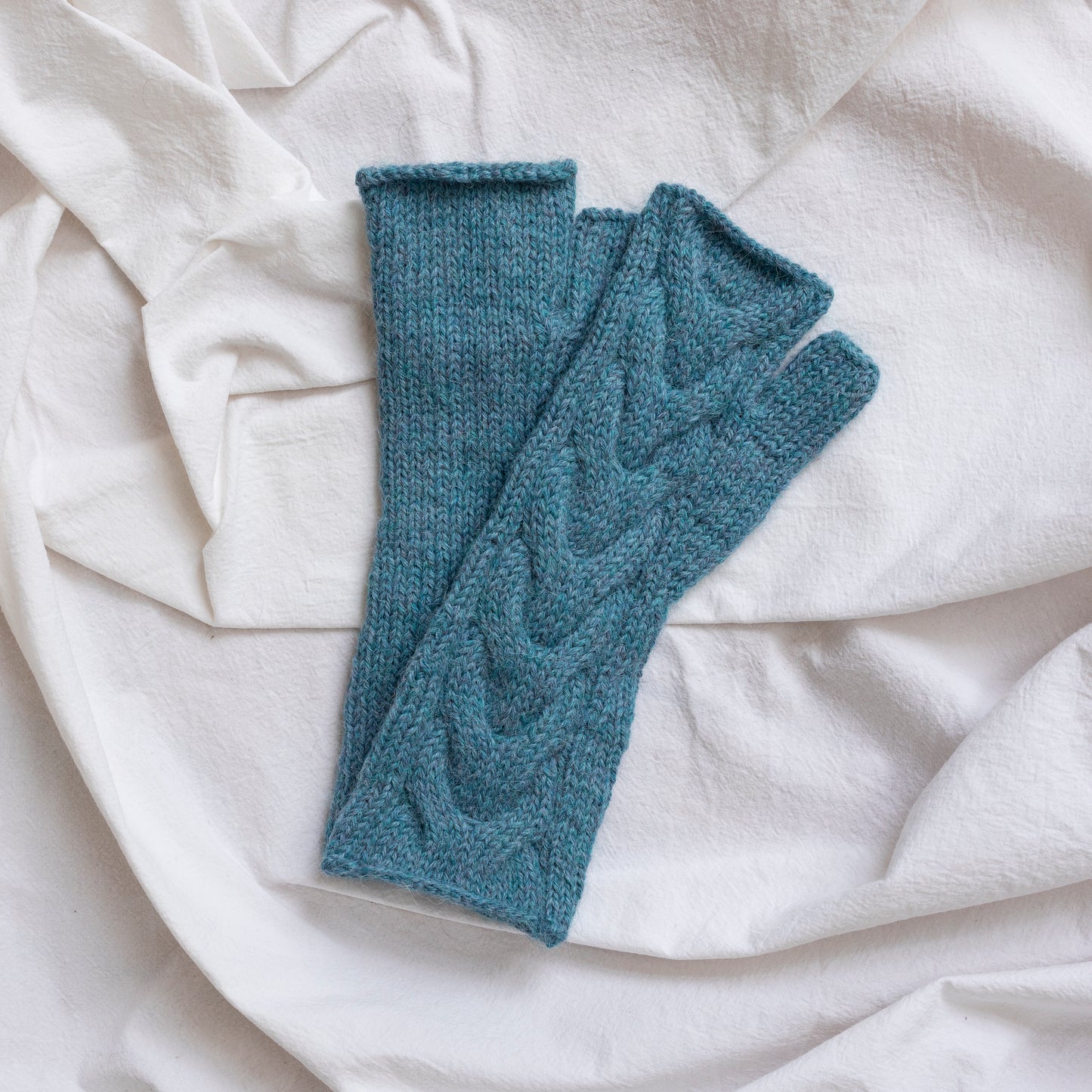 Sky blue coloured, super-soft and silky hand-knitted alpaca wool mittens.