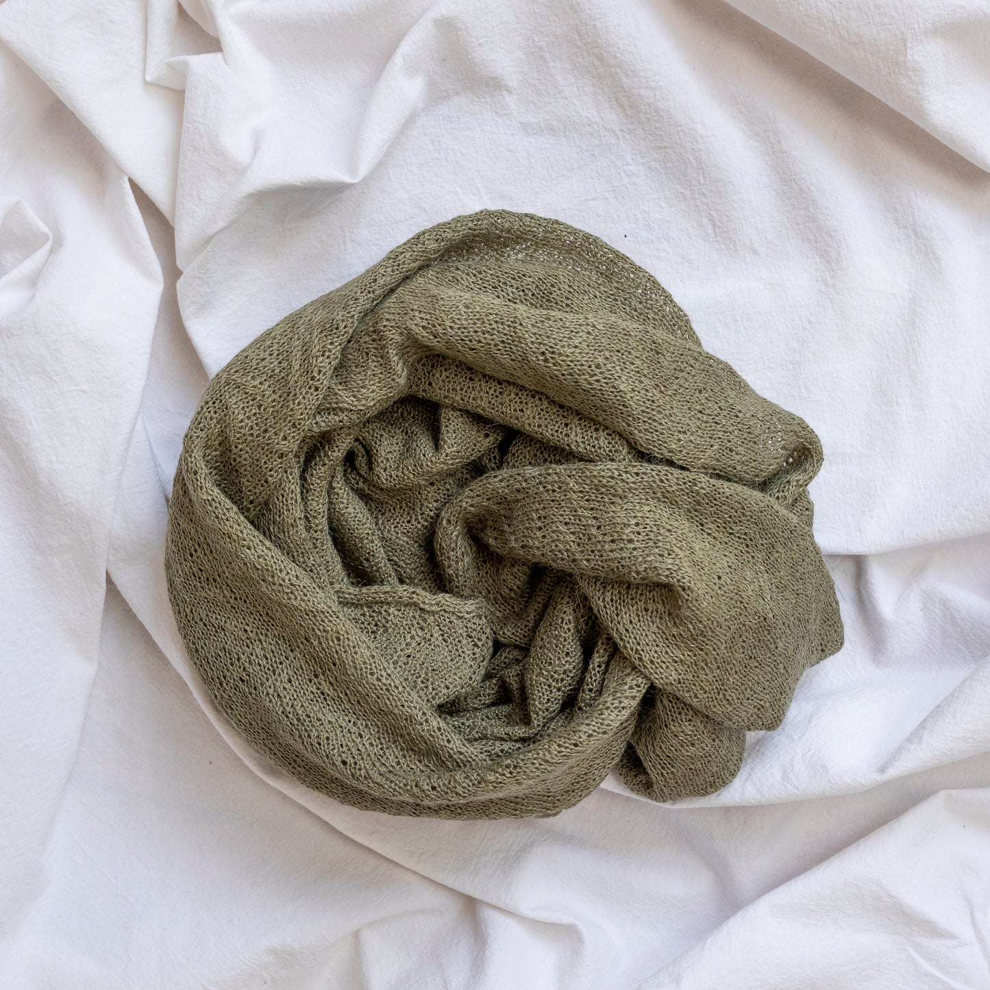 Khaki coloured lightweight and delicately woven scarf. Hand-made by artisans.