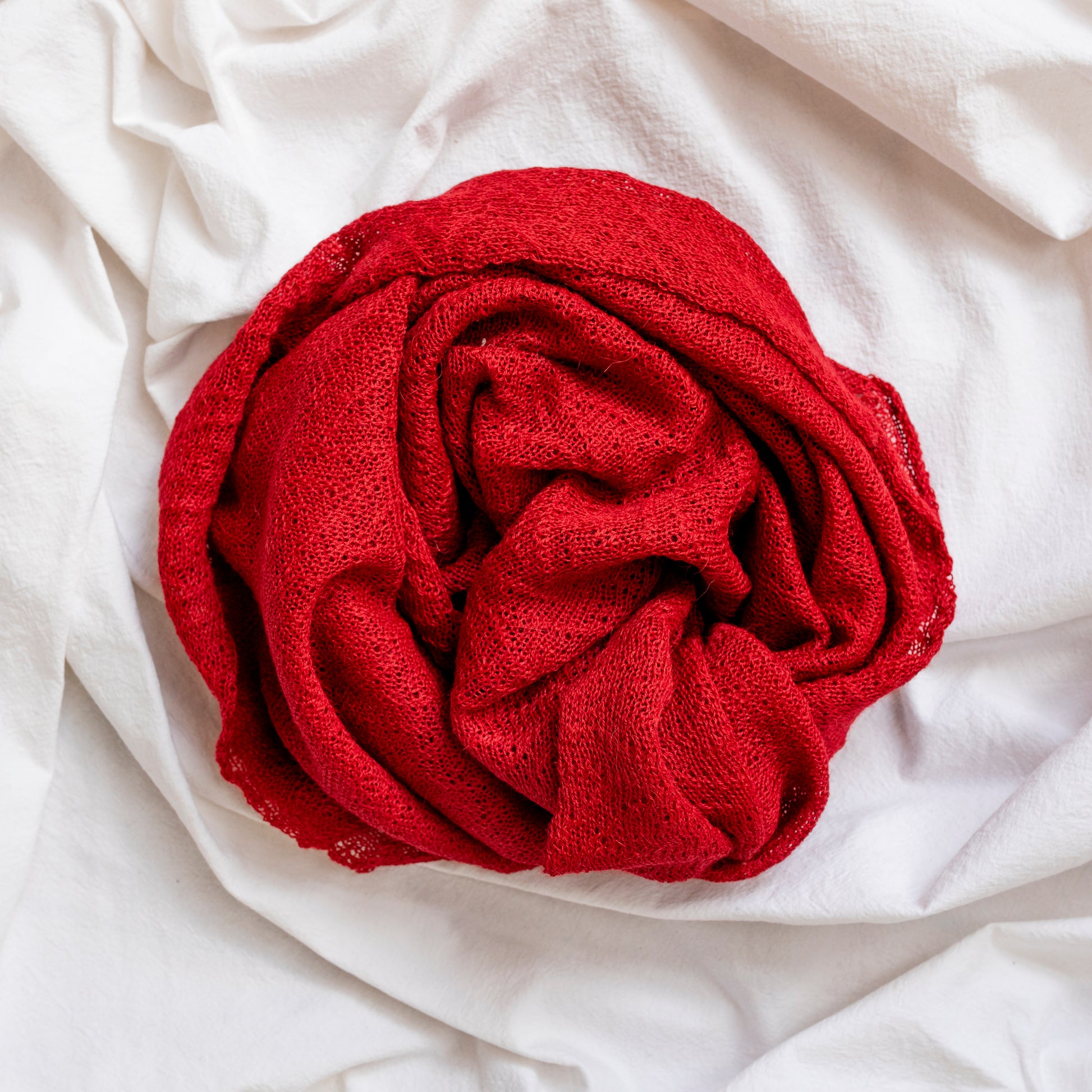 Berry red coloured lightweight and delicately woven scarf. Hand-made by artisans.