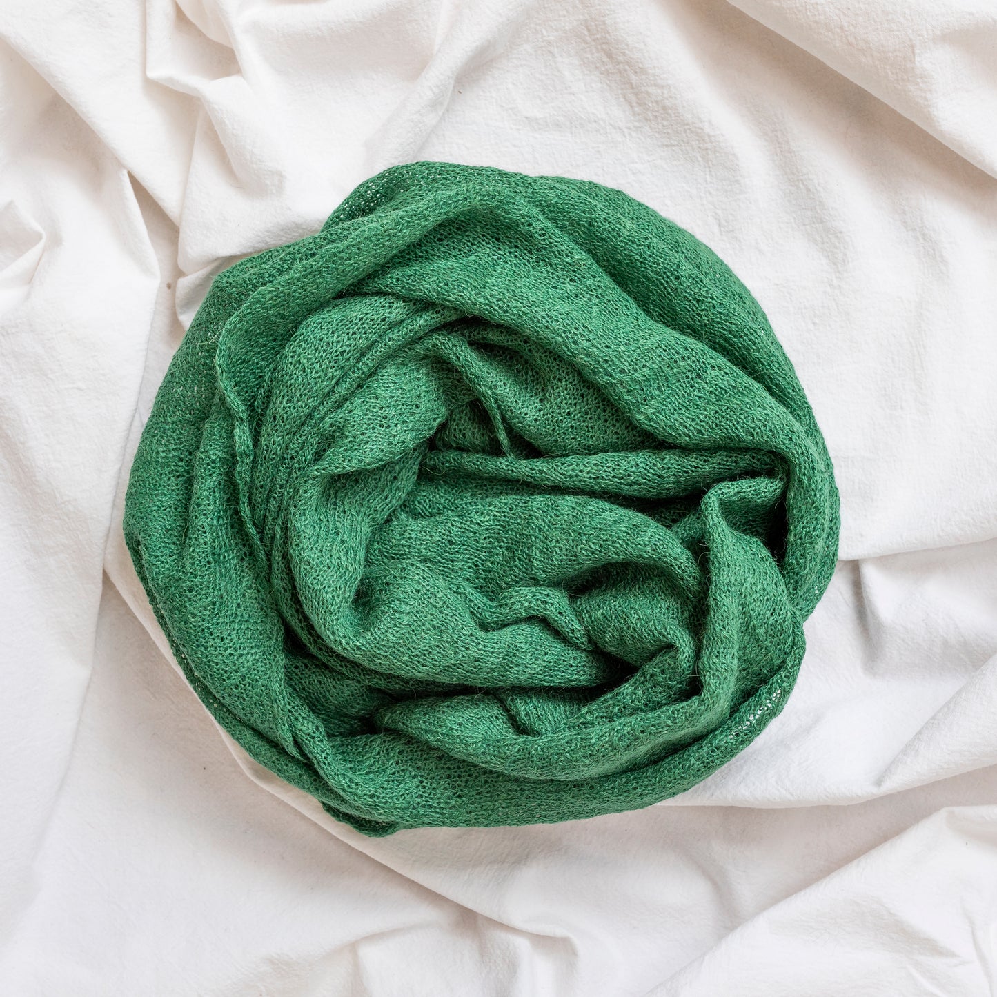 Forest green coloured lightweight and delicately woven scarf. Hand-made by artisans.