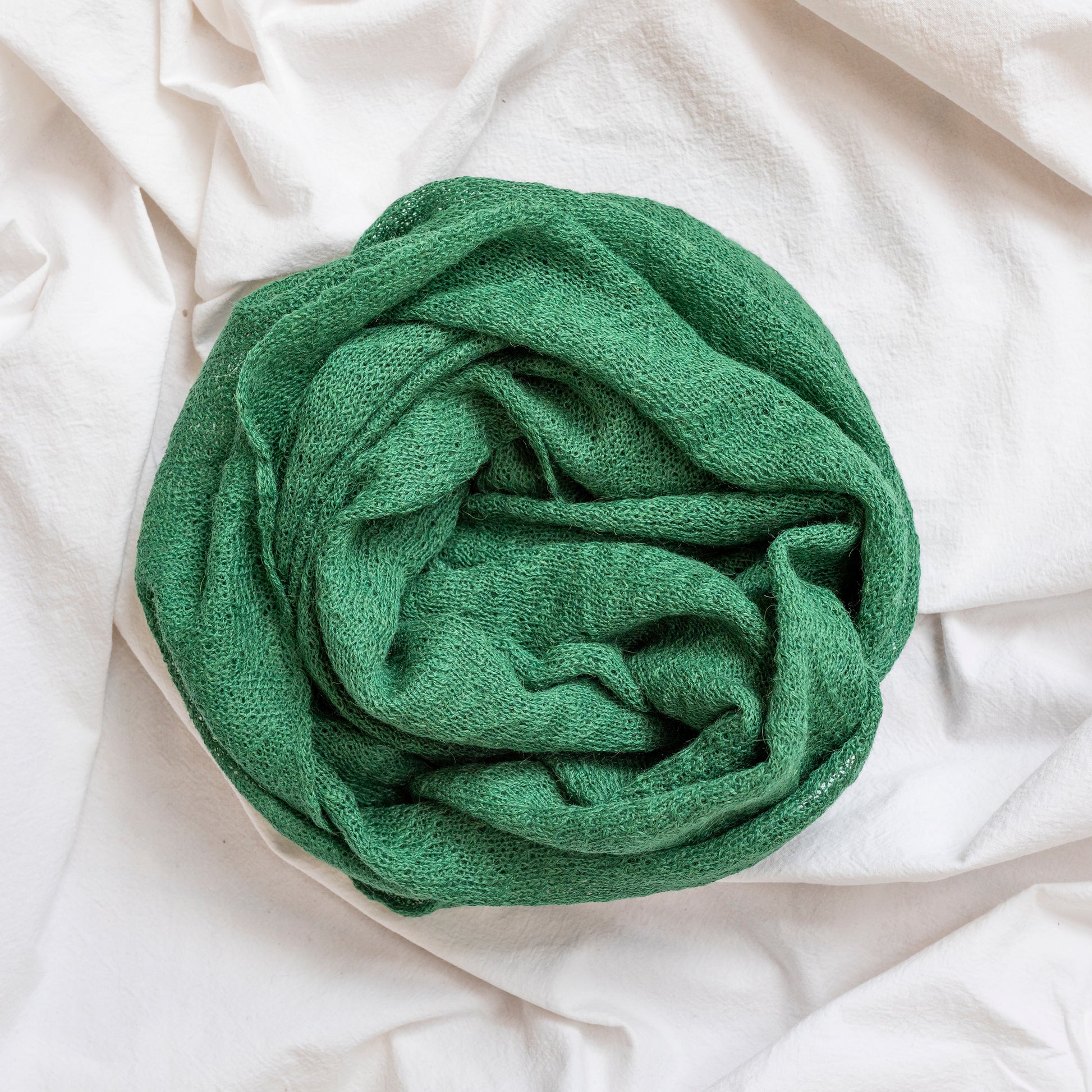 Forest green coloured lightweight and delicately woven scarf. Hand-made by artisans.